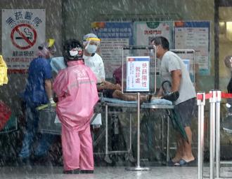 下雨天民眾在北市醫院的防疫急門診等候看診。（粘耿豪攝)