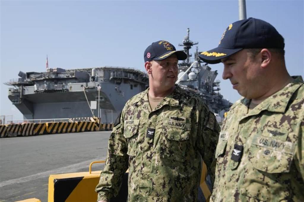 美國海軍「美利堅號」兩棲突擊艦首次停靠菲律賓首都馬尼拉的港口，進行親善訪問。圖為「美利堅號」指揮官施奈德（Shockey Snyder，左）21日訪視港口。（美聯社）